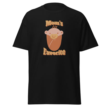 FunnyDripStore’s Moms Favorite T-Shirt in black features a cartoon baby face with a pacifier and “Moms Favorite” text in light brown—a playful, funny tee perfect for anyone who loves to show off their sense of humor!.