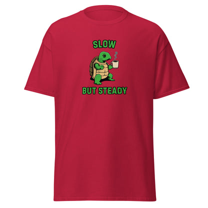 The FunnyDripStore Slow But Steady T-Shirt is a black tee with a cartoon turtle holding a coffee mug and SLOW above and BUT STEADY below in green—perfect meme shirt for coffee lovers.