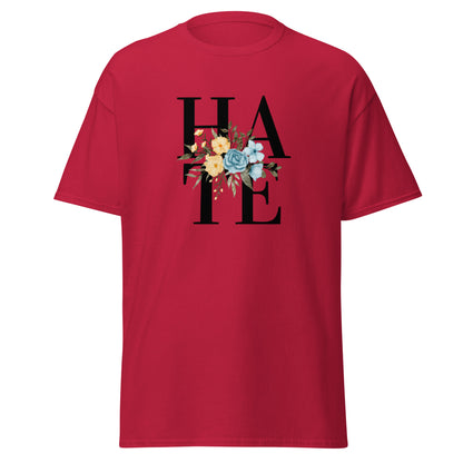 The Hate T-Shirt by FunnyDripStore features HATE in bold black text on white, overlaid with yellow and blue flowers plus green leaves—a unique, funny shirt designed to spark conversation.