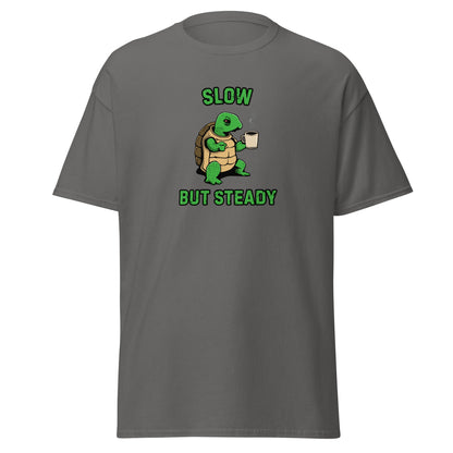 The FunnyDripStore Slow But Steady T-Shirt is a black tee with a cartoon turtle holding a coffee mug and SLOW above and BUT STEADY below in green—perfect meme shirt for coffee lovers.