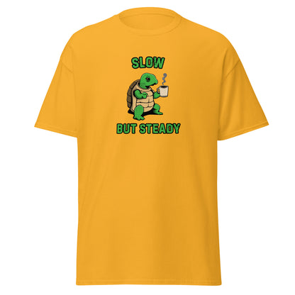 The FunnyDripStore Slow But Steady T-Shirt is a black tee with a cartoon turtle holding a coffee mug and SLOW above and BUT STEADY below in green—perfect meme shirt for coffee lovers.