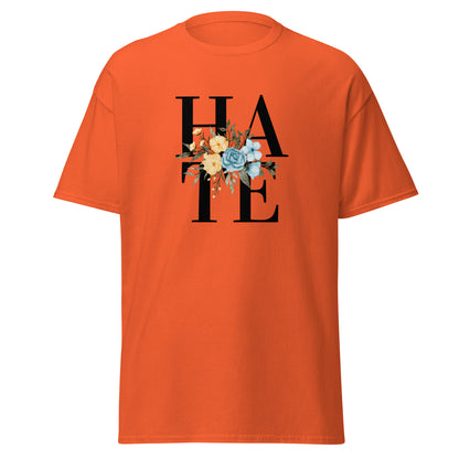 The Hate T-Shirt by FunnyDripStore features HATE in bold black text on white, overlaid with yellow and blue flowers plus green leaves—a unique, funny shirt designed to spark conversation.