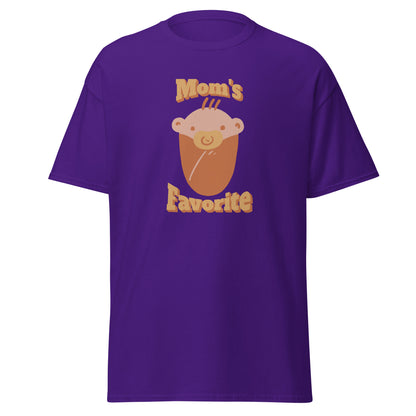FunnyDripStore’s Moms Favorite T-Shirt in black features a cartoon baby face with a pacifier and “Moms Favorite” text in light brown—a playful, funny tee perfect for anyone who loves to show off their sense of humor!.