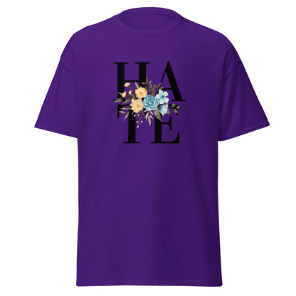 The Hate T-Shirt by FunnyDripStore features HATE in bold black text on white, overlaid with yellow and blue flowers plus green leaves—a unique, funny shirt designed to spark conversation.