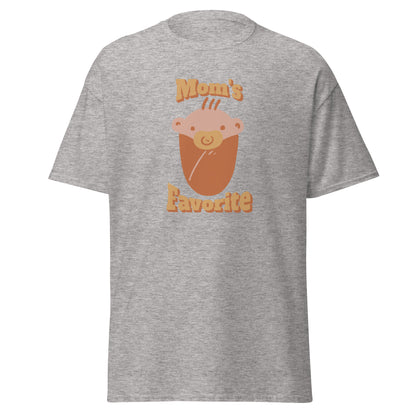 FunnyDripStore’s Moms Favorite T-Shirt in black features a cartoon baby face with a pacifier and “Moms Favorite” text in light brown—a playful, funny tee perfect for anyone who loves to show off their sense of humor!.